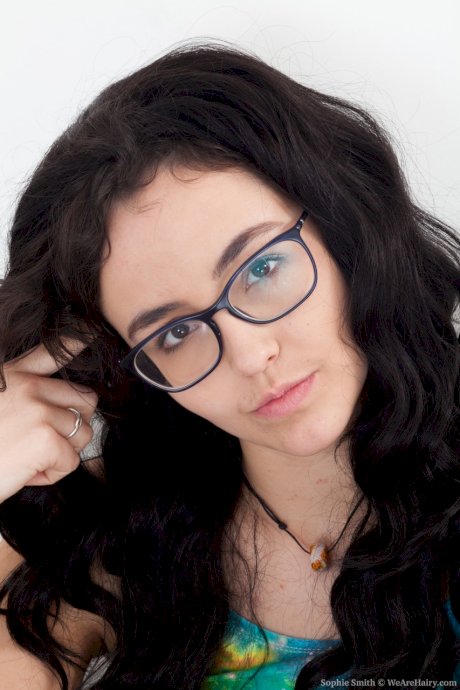 Nerdy teen Sophie Smith exposes her hairy pussy and poses on a chair