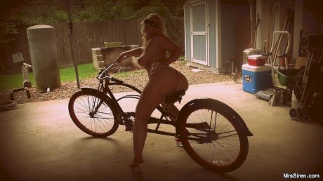 Bootylicious MILF Dee Siren riding a bike in her sexy g-string panties