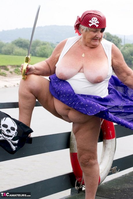 Fat British granny exposes herself on a bridge while sporting pirate attire