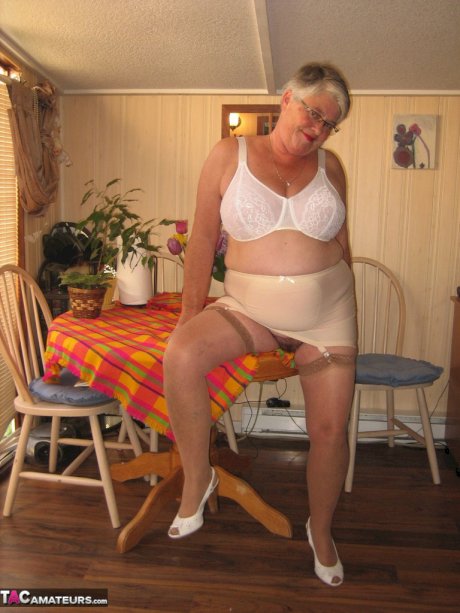 Fat granny Girdle Goddess exposes her huge boobs in a girdle and nylons