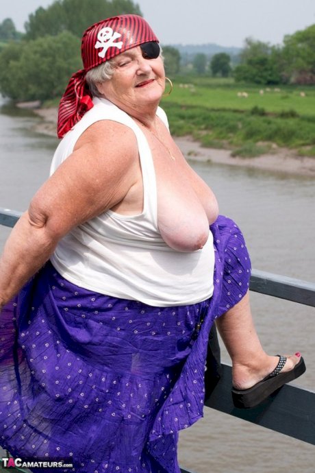 Fat British granny exposes herself on a bridge while sporting pirate attire