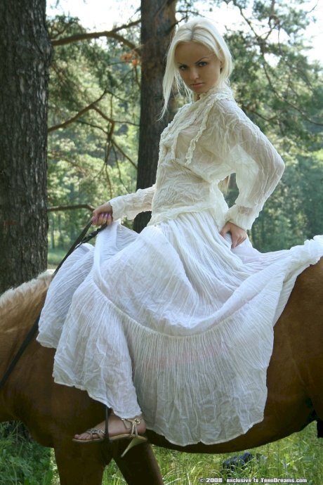 Teen equestrian with tiny titties Ira doffs her white dress and poses naked - Photo 1