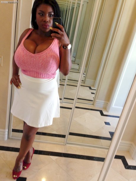 Curvy black haired ebony Maserati XXX displays her massive melons in a solo