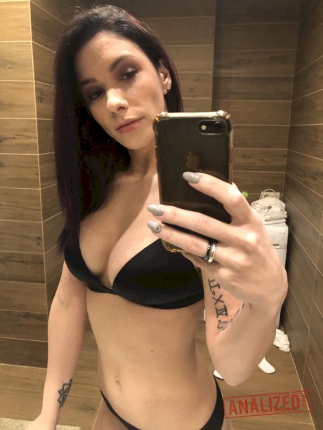 Brunette solo girl takes mirror selfies while getting naked in a bathroom