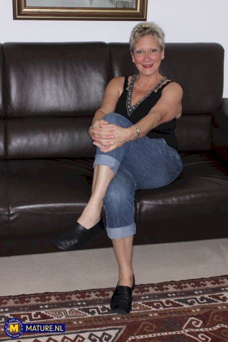 Busty granny Angie takes a cumshot on her big tits after wild hardcore sex - Photo 1