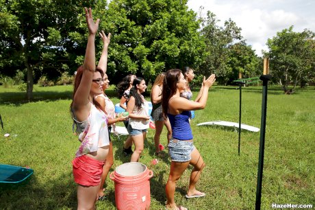 Pretty naked lesbians are standing naked and showing their bodies outdoor