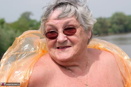 Obese oma Grandma Libby doffs a see-through raincoat to get naked on a bridge