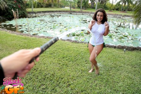 Busty Latina wets herself down in the fountain wearing a white t-shirt