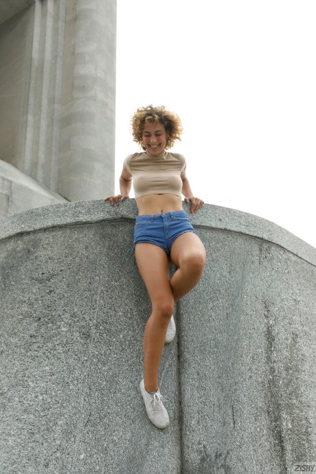 Slim amateur Sylvia Belotti poses in tight denim shorts & a crop top outdoors