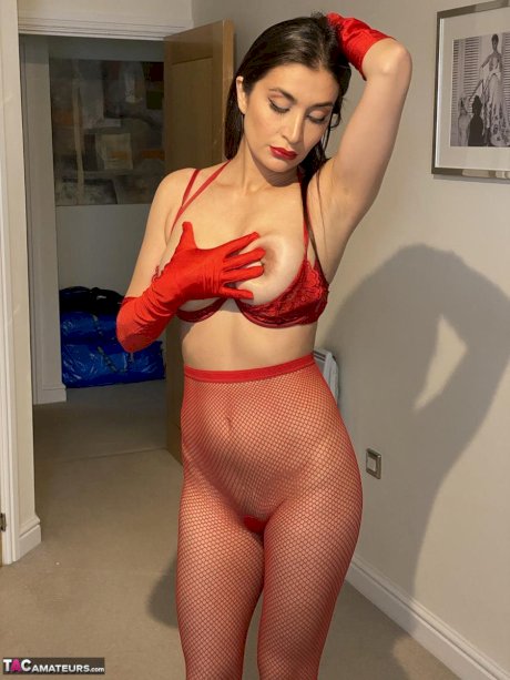 Solo girl Sexy Alinaxxx fondles her big tits while wearing red velvet gloves