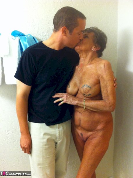 Dirty amateur granny shows her sexy naked body and kisses a young stud