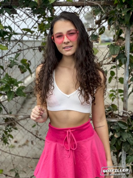 Young brunette Liz Jordan models a bikini at a marina before sex at home