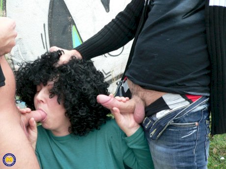 Curly-haired amateur prostitute with big tits Johanna sucks 2 dicks in public - Photo 6