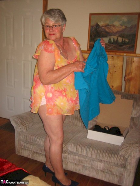 Obese granny Girdle Goddess wakes up from a nap and precedes to strip naked