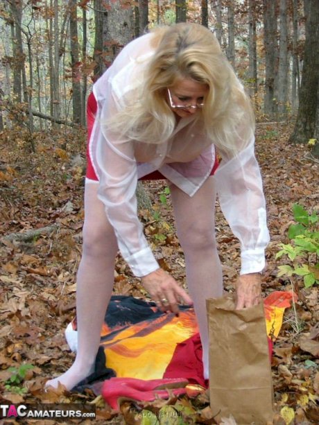 Horny granny Adonna removes her panties and toys herself in the woods