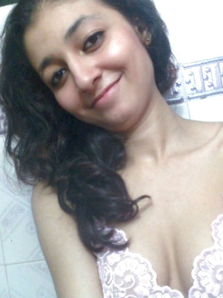 Indian solo girl holds her face firm while letting nipples free of lingerie