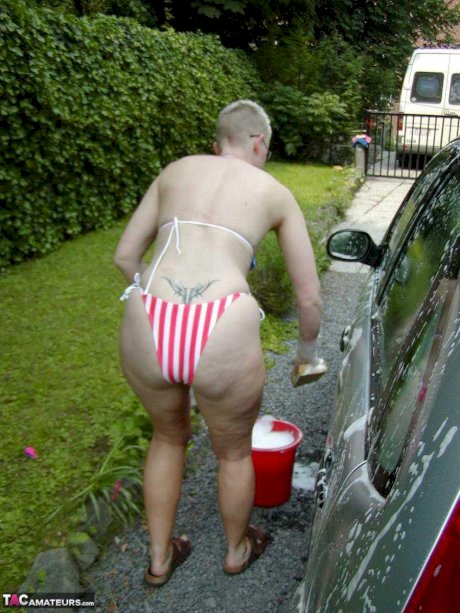 Older blonde Tiffany Pearl washes her car while wearing a bikini porn pics
