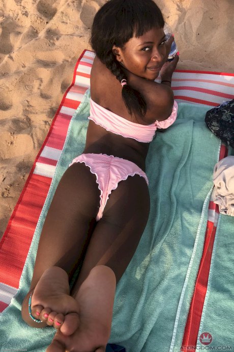 Petite ebony Noemie Bilas exposing her tits, pussy and feet in a solo