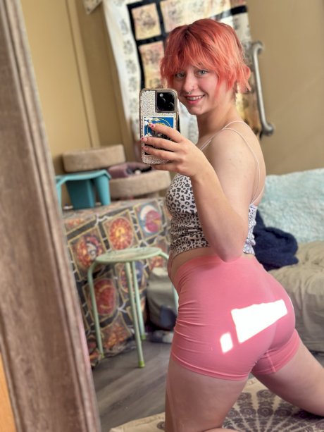 Pink-haired amateur slut Redhead Abby poses dressed up in the mirror