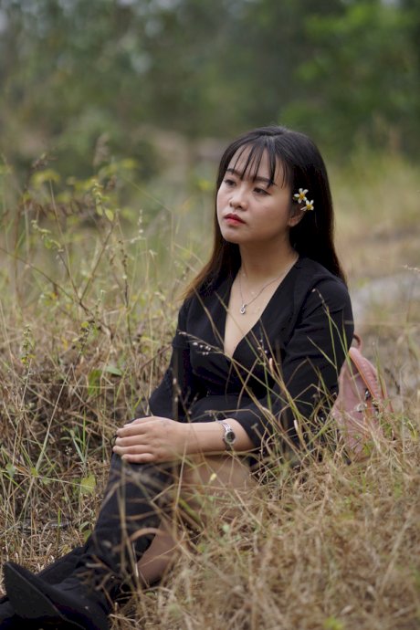 Gorgeous Asian babe posing in her black dress and boots in nature