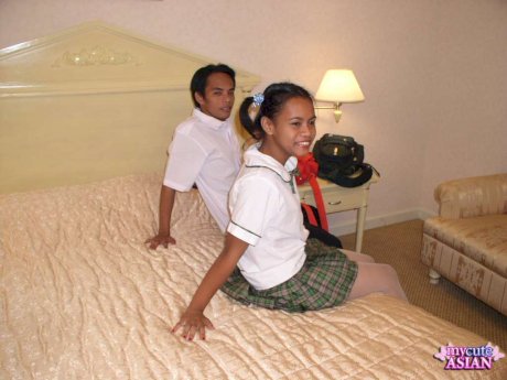 Asian schoolgirl gets cum on her innocent looking face on her parent's bed