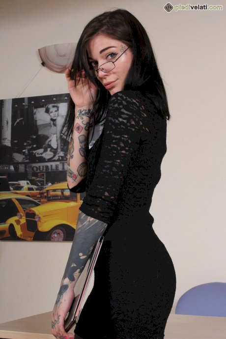 Tattooed girl Refen removes her red soled heels while wearing pantyhose
