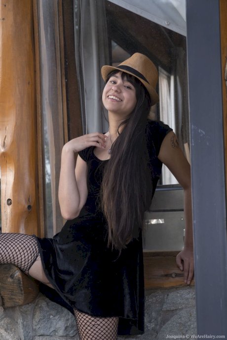 Brunette amateur teen Joaquina strips her ripped fishnets and poses outdoors - Photo 2