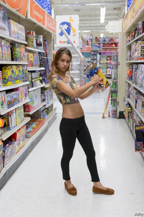 Teen girlfriend Uma Jolie flashing her titties and her ass in a toy store