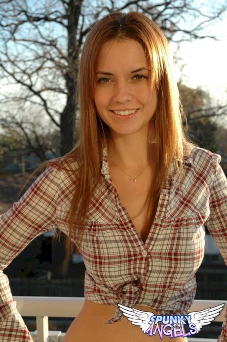 Redheaded country girl models non nude in tied up shirt and denim jeans porn pics