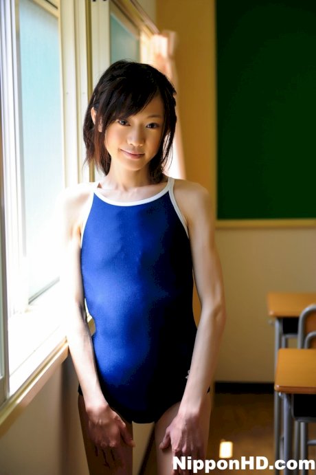 Tiny Japanese girl model non nude in a swimsuit on school desk