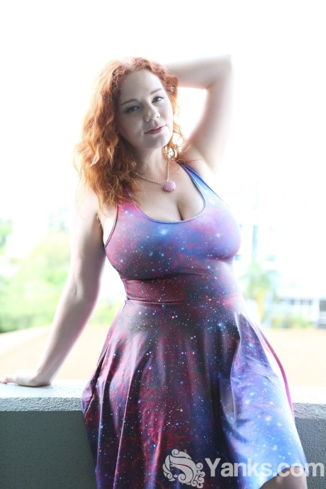 Chubby solo girl with curly red hair unleashes her incredible breasts