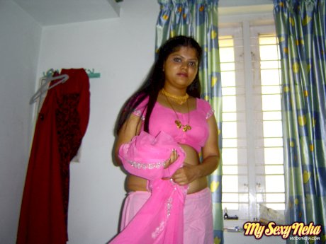Plump Indian girl Neha gets totally naked on her bed in solo action