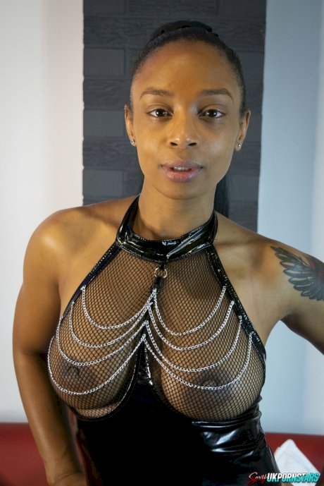 Ebony model Alicia Rhodes poses in a see-through top and over the knee boots