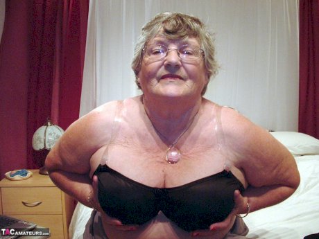 Obese granny Grandma Libby creams her vagina after getting naked on her bed